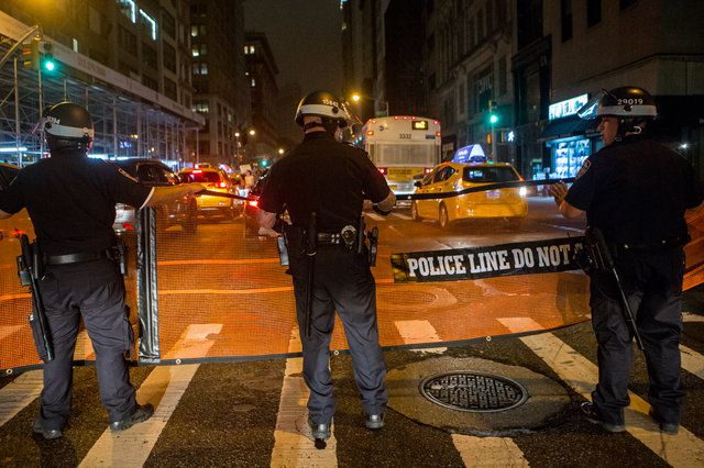 NYPD officers use a net to contain demonstrators during a protest this July.
